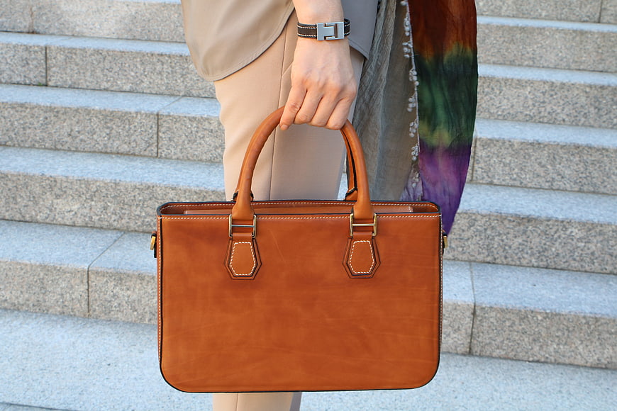 Handcrafted Tan Leather Briefcase Held By Person On Stone Steps