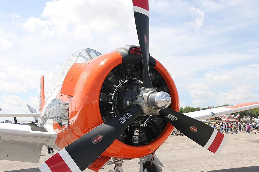 Close-up of vintage orange radial engine airplane propeller