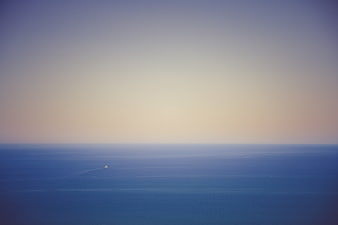 Minimalist Ocean Horizon with Distant Boat at Dusk