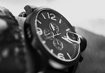 Close-up of black chronograph wristwatch on man's arm