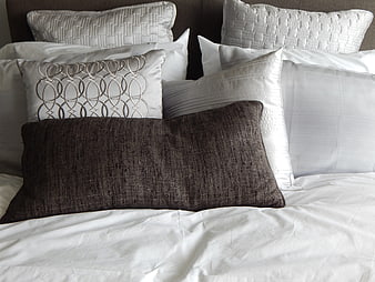 Luxury Hotel Bed with White Linens and Textured Pillows