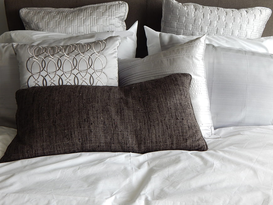 Luxury Hotel Bed with White Linens and Textured Pillows