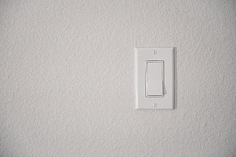 White Rocker Light Switch on Textured Wall