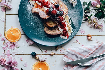 Overhead view of French toast with berries and flowers
