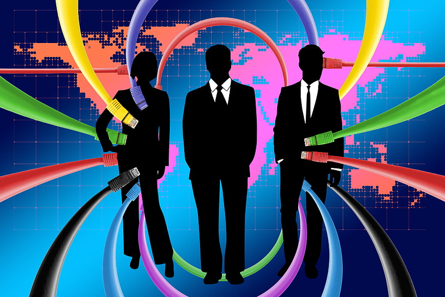 Silhouettes of business people connected by colorful network cables