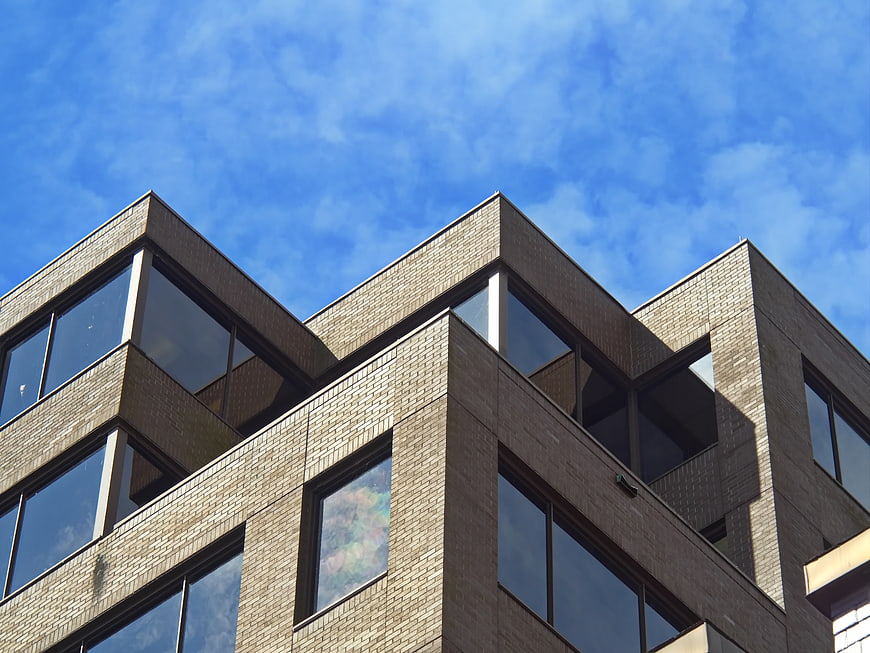 Modern Brick Office Building Exterior with Blue Sky