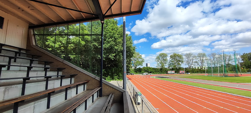 Empty stadium bleachers overlooking red running track