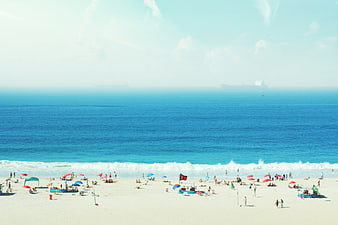 Wide Beach Scene with Blue Ocean and Summer Tourists