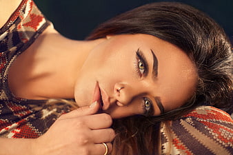 Close-up portrait of a beautiful brunette woman lying down