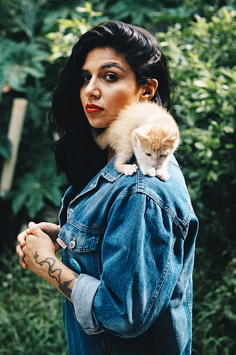 Woman with Orange Kitten on Shoulder in Garden