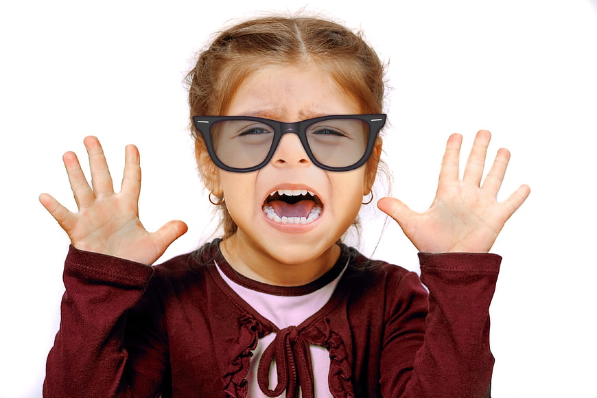 Cute little girl screaming with hands up wearing oversized glasses