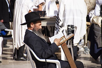 Orthodox Jewish man reading prayer book in Jerusalem