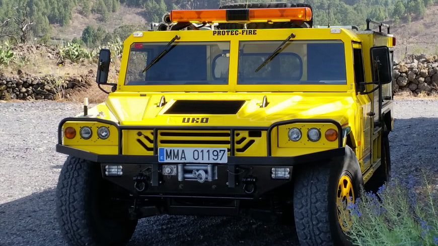 Yellow Off-Road Fire Truck in Rural Landscape
