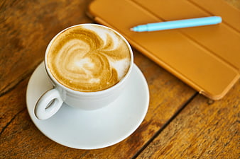 Latte Art Coffee Cup with Tablet on Wooden Table