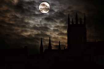 Full Moon Over Silhouetted Gothic Castle at Night
