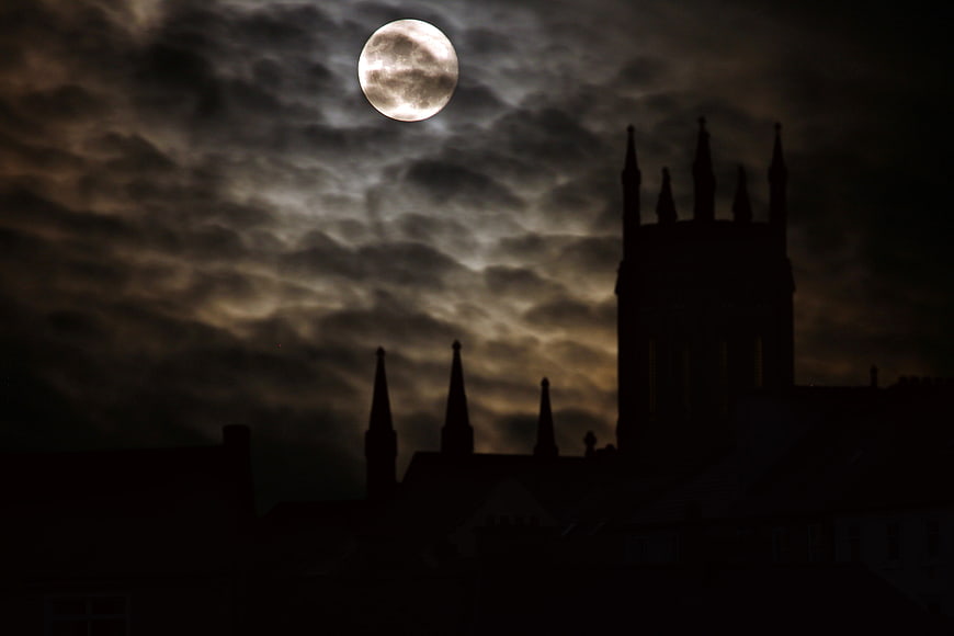 Full Moon Over Silhouetted Gothic Castle at Night