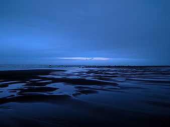 Serene Blue Hour Beach Landscape with Wet Sand Reflections