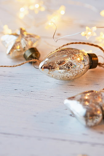 Vintage Christmas Ornaments with Fairy Lights on White Wood