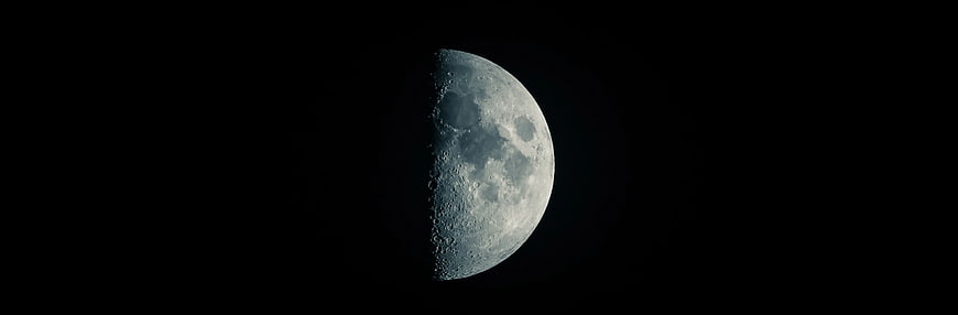 Crescent Moon in Black Night Sky with Craters