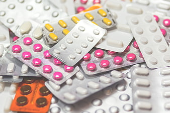 Assorted blister packs of colorful pills and tablets