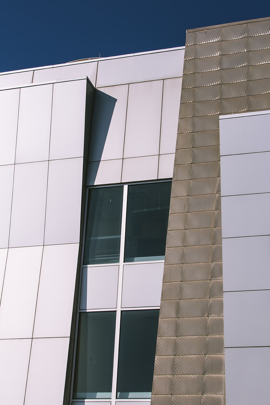 Modern Building Facade with White Panels and Textured Wall