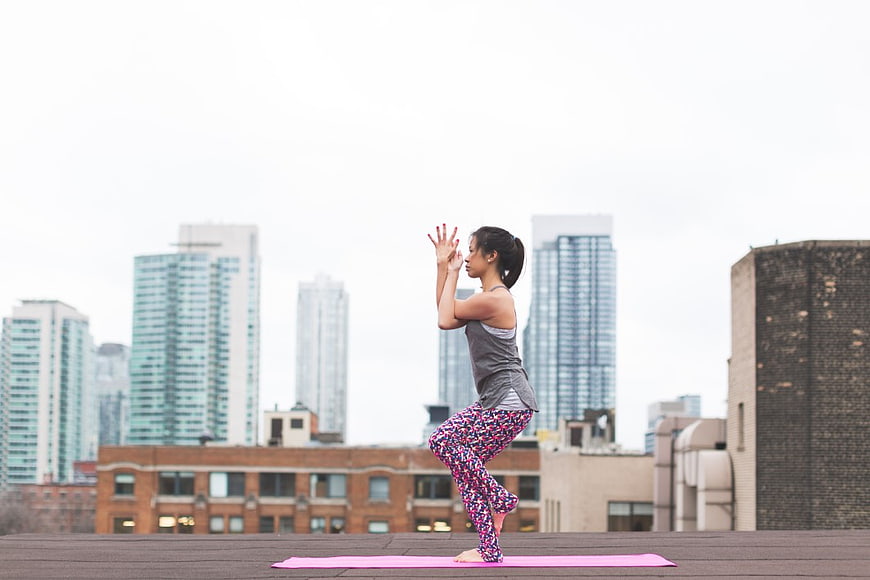Woman Practicing Yoga on Urban Rooftop
