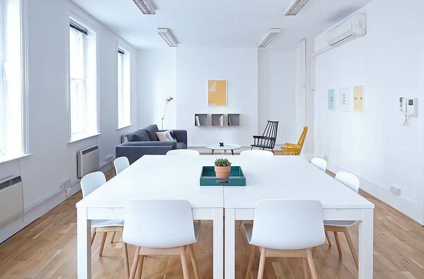 Modern minimalist white office interior with large table