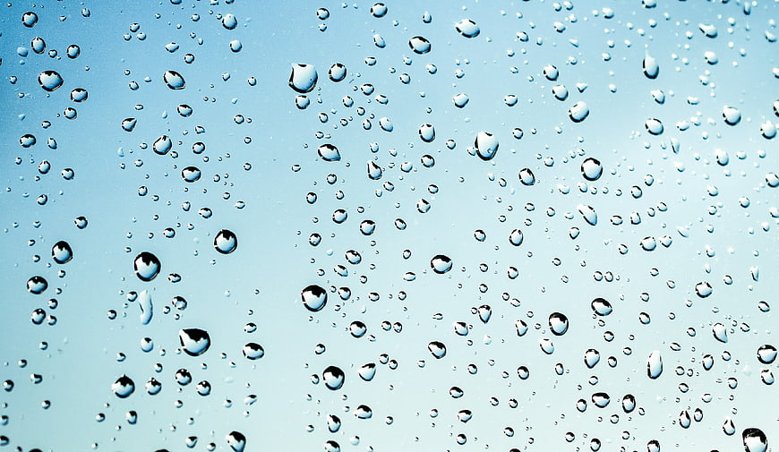 Water Droplets on Blue Glass Surface Background