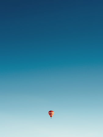 Minimalist Red Hot Air Balloon Against Gradient Blue Sky