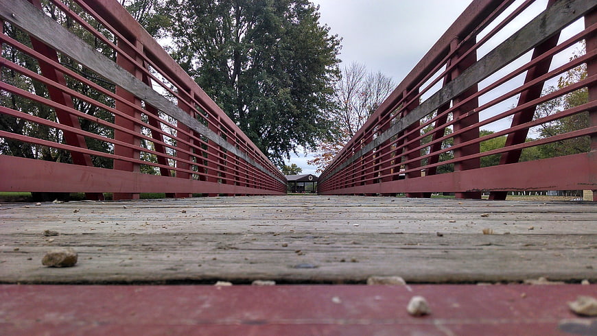 Low angle view of red wooden pedestrian bridge