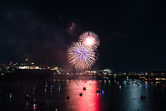 Fireworks Display Over City Harbor at Night