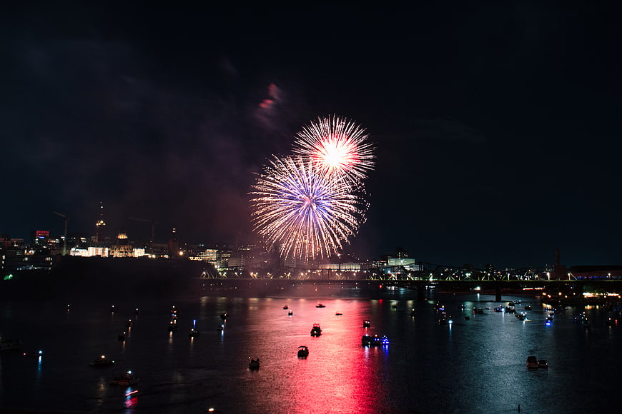 Fireworks Display Over City Harbor at Night
