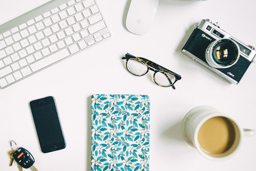 Flat Lay of Creative Workspace with Camera and Coffee