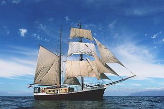 Classic Two-Masted Schooner Sailing on Blue Ocean