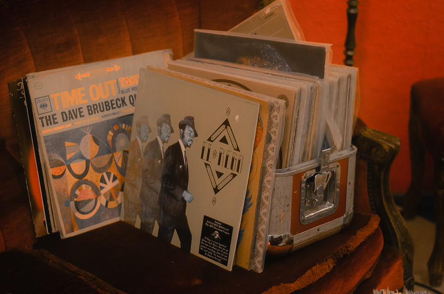 Vintage vinyl records in a retro suitcase on a chair