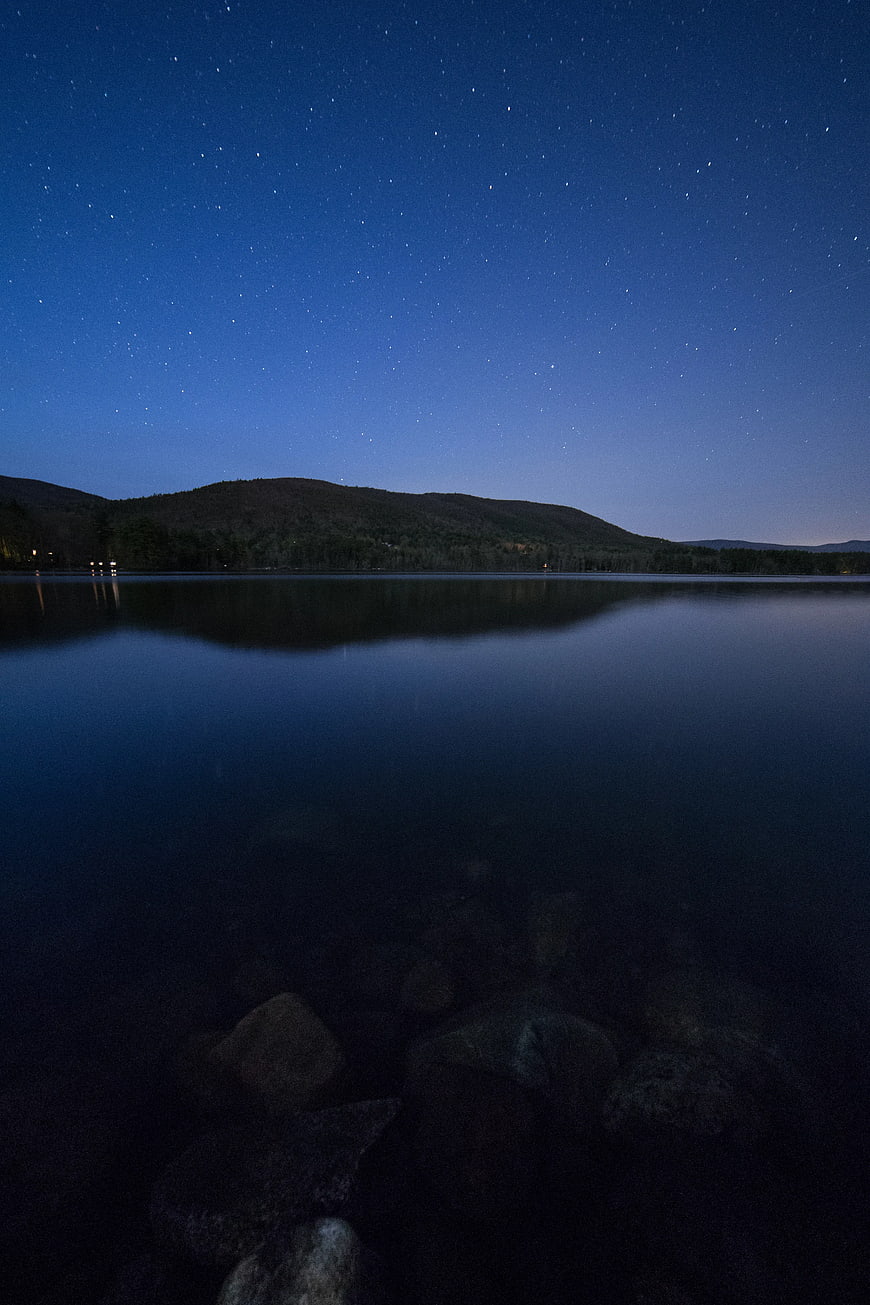 Serene Lake Reflection Under Starry Night Sky