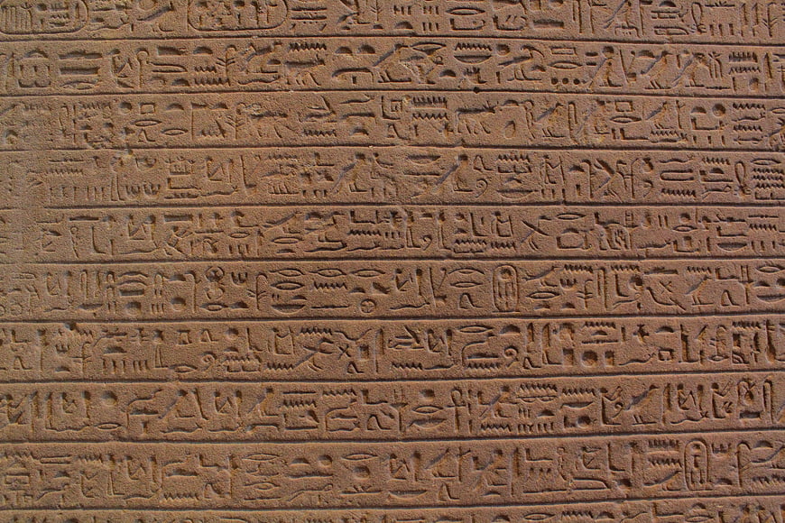 Close-up of ancient Egyptian hieroglyphs carved in stone
