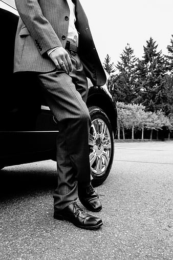 Businessman in Suit Standing by Luxury Car
