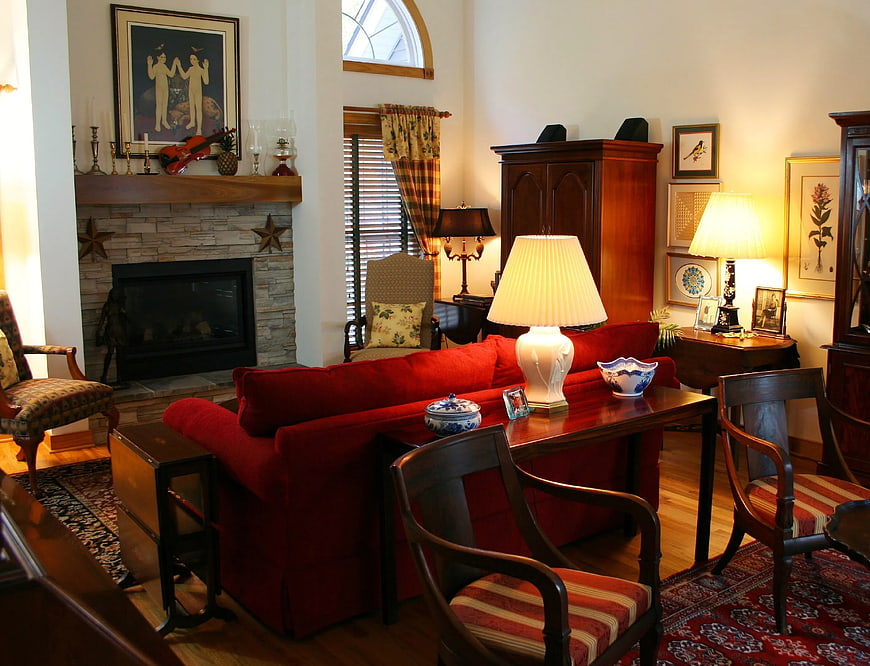 Cozy Living Room with Red Sofa and Stone Fireplace