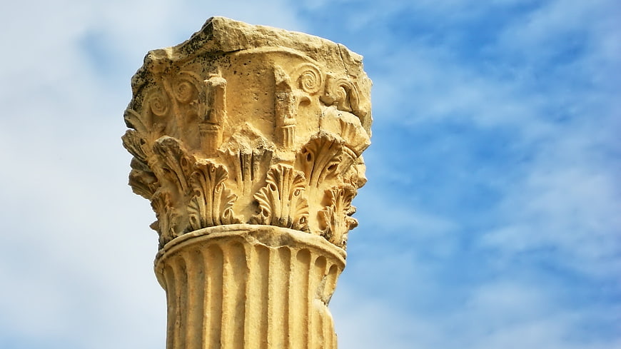 Ancient Corinthian Column Capital Detail Against Blue Sky