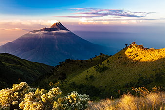 Volcanic Mountain Landscape at Sunrise with Golden Light and Mist