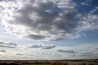 Dramatic Cloudy Sky Over Autumn Marsh Landscape
