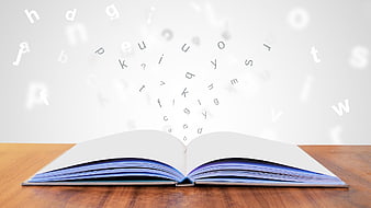 Open book with floating alphabet letters on wooden table