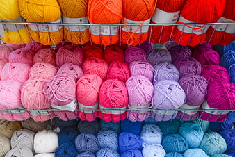 Colorful Yarn Skeins Organized on Store Shelves