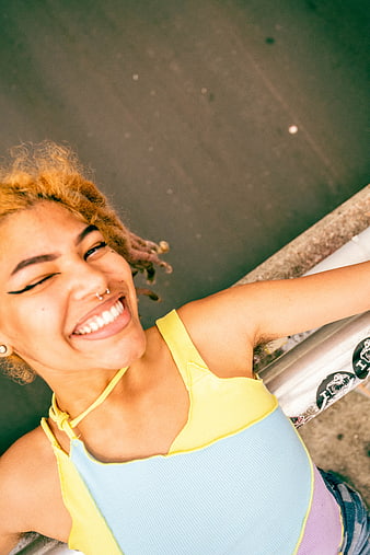 High Angle Portrait of Smiling Young Woman with Dreads