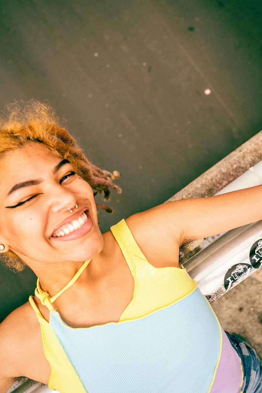 High Angle Portrait of Smiling Young Woman with Dreads