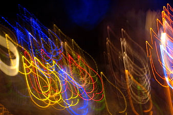 Abstract colorful light trails on dark background