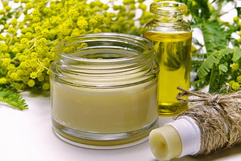 Natural organic skincare products with mimosa flowers