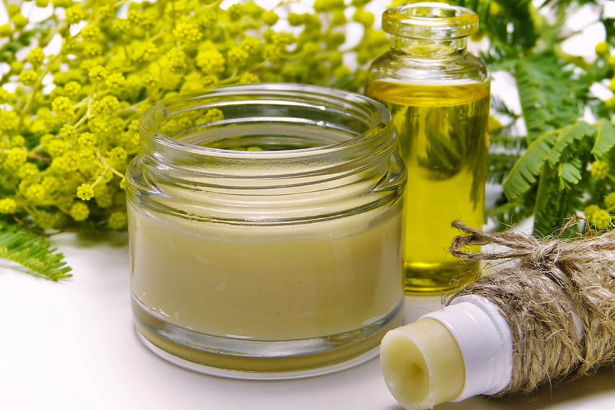 Natural organic skincare products with mimosa flowers