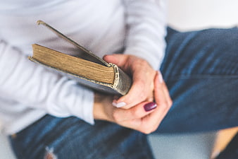 Close-up of hands holding a vintage book